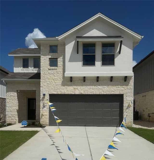 142 White Horses Dr, Kyle, TX 78640 - view of front of property featuring a garage, stone siding, driveway, and stucco siding