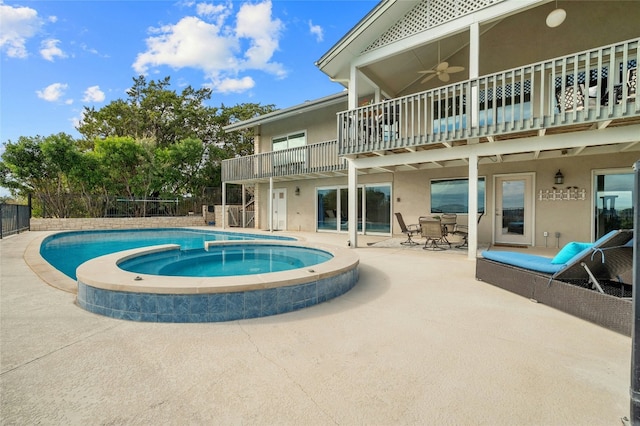 view of pool featuring a patio area, ceiling fan, and a pool with connected hot tub