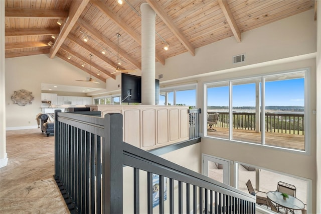 interior space featuring wood ceiling, visible vents, baseboards, beamed ceiling, and track lighting