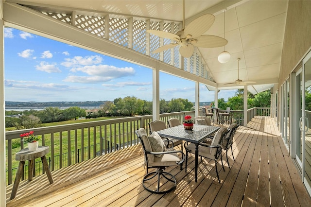 wooden deck with ceiling fan, outdoor dining area, and a yard