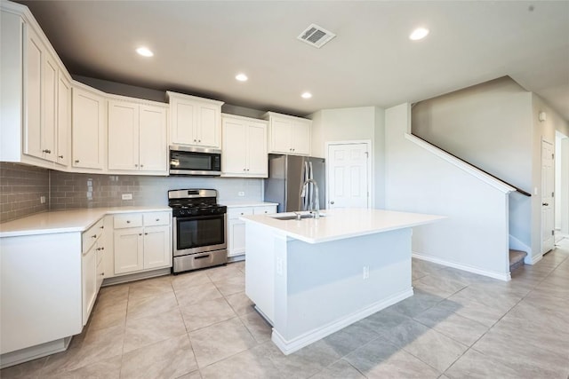 kitchen with tasteful backsplash, visible vents, stainless steel appliances, light countertops, and recessed lighting