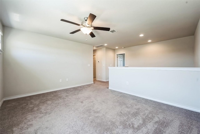 carpeted empty room featuring baseboards, a ceiling fan, visible vents, and recessed lighting