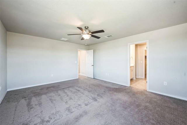 interior space with carpet floors, visible vents, baseboards, and a ceiling fan