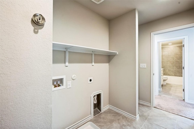 washroom with laundry area, hookup for a gas dryer, hookup for a washing machine, hookup for an electric dryer, and light tile patterned flooring