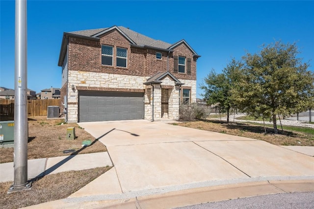 traditional home featuring driveway, stone siding, fence, cooling unit, and brick siding