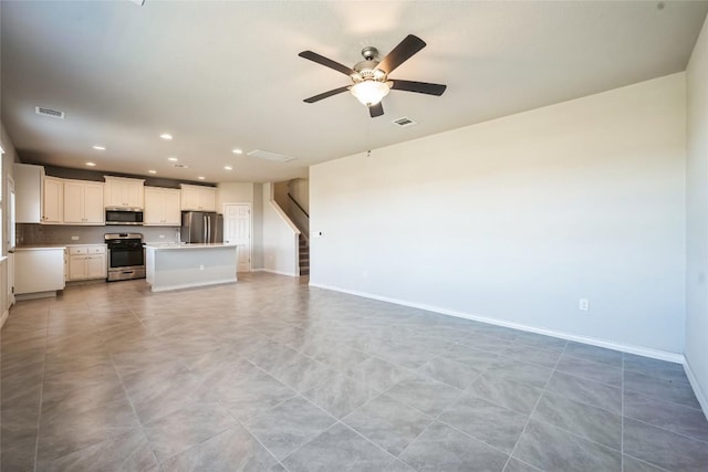 unfurnished living room featuring baseboards, visible vents, ceiling fan, stairs, and recessed lighting