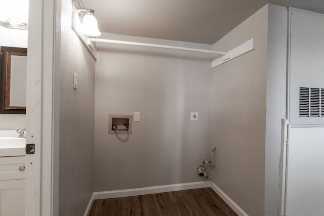 laundry area with laundry area, baseboards, dark wood-style floors, washer hookup, and electric dryer hookup