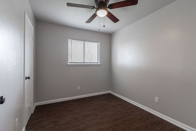 unfurnished room featuring baseboards, dark wood finished floors, and a ceiling fan