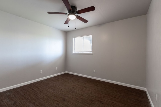 unfurnished room with dark wood-style floors, ceiling fan, and baseboards