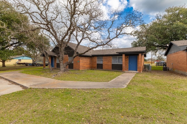 889 Lake St Unit 889A & B 890A & B, Somerville, TX 77879 - view of front of house with a front yard, brick siding, central AC, and a shingled roof