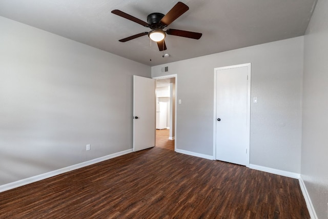 unfurnished bedroom with ceiling fan, wood finished floors, and baseboards