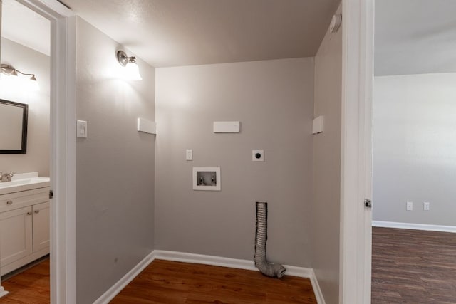 laundry area featuring baseboards, hookup for a washing machine, wood finished floors, and hookup for an electric dryer