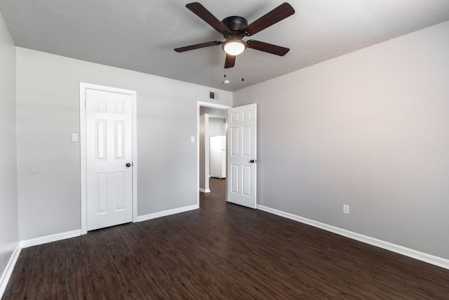 unfurnished bedroom with visible vents, dark wood-type flooring, a ceiling fan, and baseboards