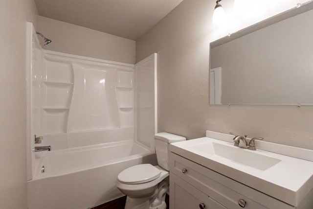 bathroom with toilet, a textured wall, vanity, and bathing tub / shower combination