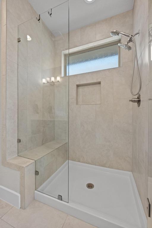 full bath with a stall shower and tile patterned floors