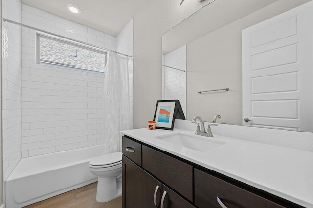 bathroom with vanity, wood finished floors, toilet, and shower / bathtub combination with curtain