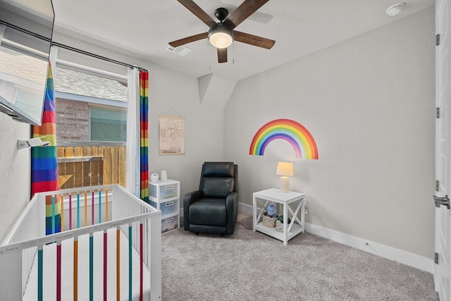 carpeted bedroom featuring visible vents, ceiling fan, a crib, and baseboards