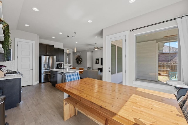 dining room with recessed lighting, ceiling fan, and wood finished floors