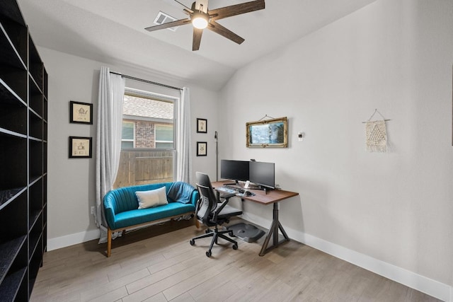 office space featuring lofted ceiling, visible vents, a ceiling fan, wood finished floors, and baseboards