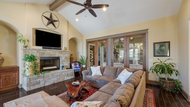 living area featuring vaulted ceiling with beams, wood finish floors, a fireplace, and baseboards