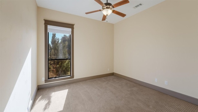 empty room with light carpet, visible vents, baseboards, and a ceiling fan