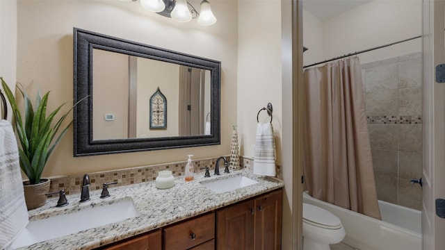 full bathroom with shower / bath combo, a sink, toilet, and double vanity