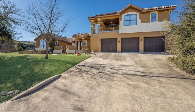 mediterranean / spanish house featuring a balcony, a garage, driveway, stucco siding, and a front yard