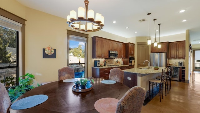 dining space with wine cooler, an inviting chandelier, visible vents, and recessed lighting