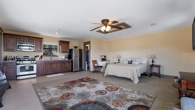 bedroom with light tile patterned flooring, a sink, visible vents, freestanding refrigerator, and attic access