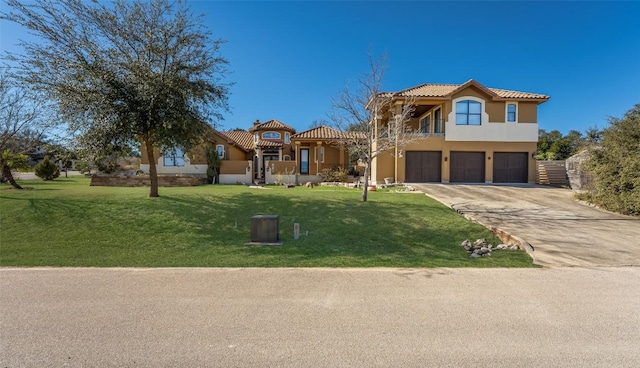 mediterranean / spanish-style home featuring stucco siding, an attached garage, driveway, a tiled roof, and a front lawn