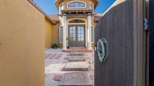 15100 Canary St, Austin, TX 78734 - doorway to property featuring stucco siding, french doors, and a tiled roof