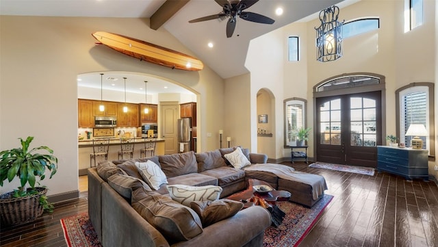 living area with dark wood-style floors, french doors, beamed ceiling, and arched walkways