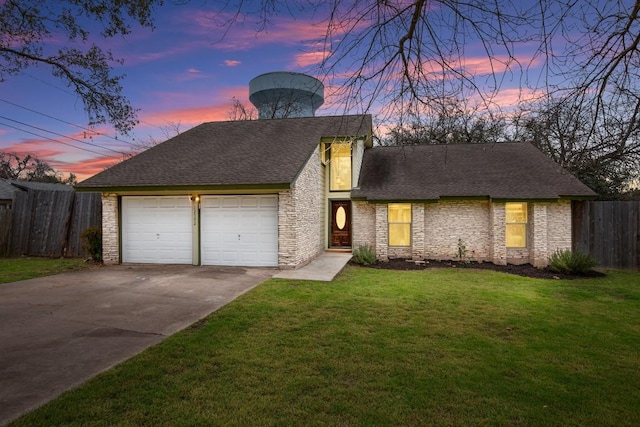 view of front facade with stone siding, a garage, a lawn, fence, and driveway