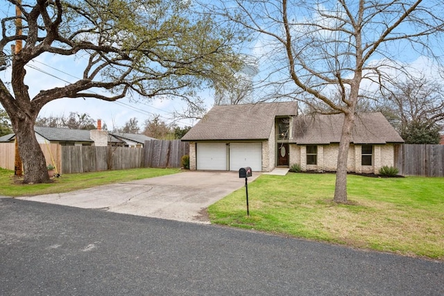 view of front facade featuring a garage, a front yard, driveway, and fence