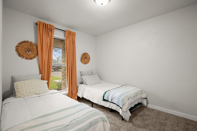 bedroom featuring baseboards and carpet flooring