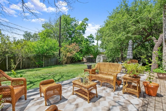 view of patio with a storage shed, a fenced backyard, and an outbuilding