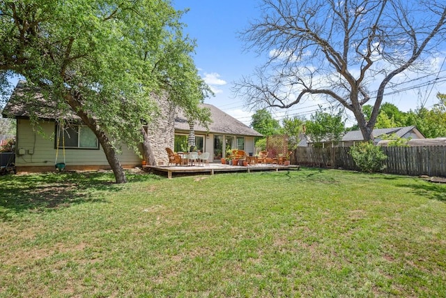 view of yard with a deck and fence