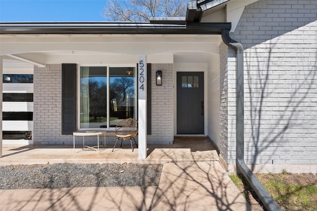 property entrance with brick siding