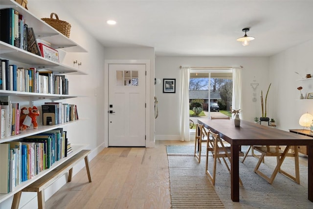 interior space with baseboards, recessed lighting, and light wood-style floors