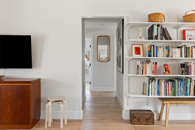 interior space featuring baseboards and wood finished floors