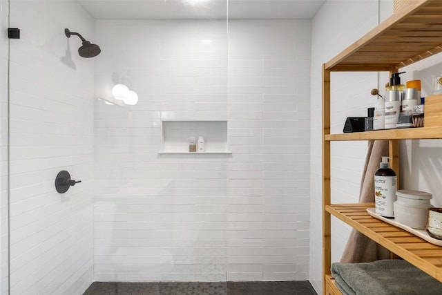 full bath with a tile shower