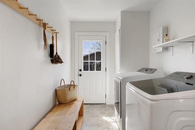 laundry room with light tile patterned floors, laundry area, washing machine and dryer, and electric panel