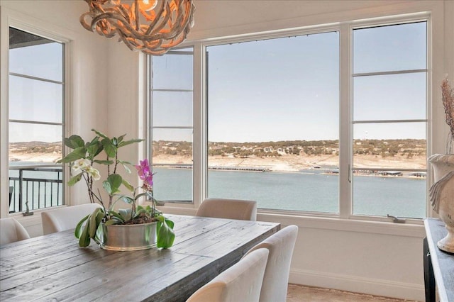 dining room featuring an inviting chandelier, baseboards, and a wealth of natural light