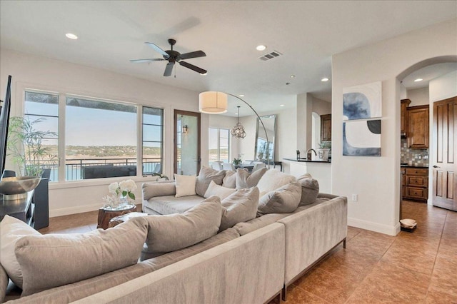 living room featuring baseboards, visible vents, and recessed lighting