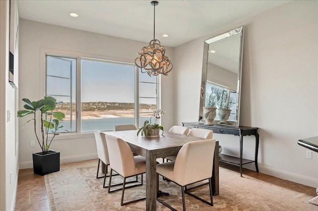 dining room featuring recessed lighting, plenty of natural light, and baseboards