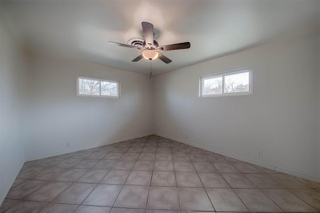 unfurnished room featuring a healthy amount of sunlight, baseboards, and a ceiling fan