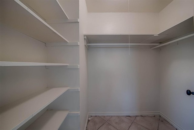 walk in closet featuring tile patterned flooring