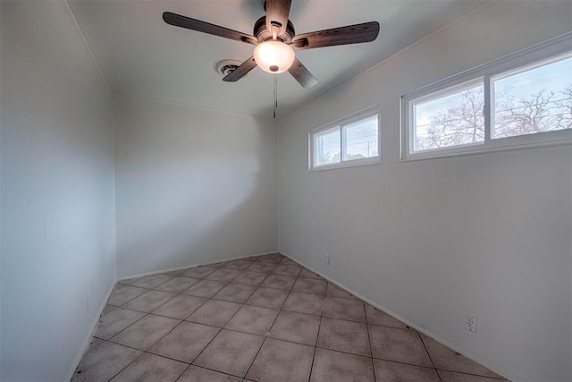 spare room with crown molding and a ceiling fan