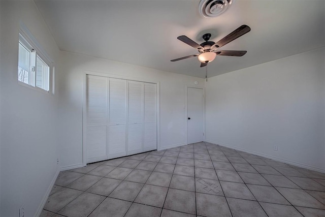 unfurnished bedroom featuring baseboards, ceiling fan, visible vents, and a closet