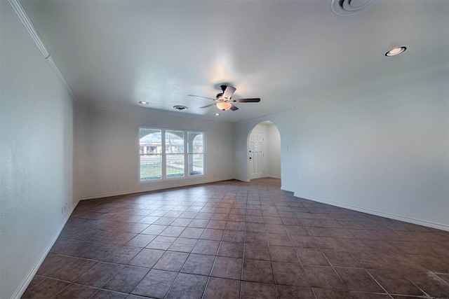 unfurnished room with arched walkways, visible vents, ornamental molding, ceiling fan, and baseboards